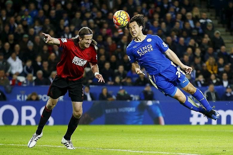 Leicester City's Shinji Okazaki beats West Bromwich Albion's Jonas Olsson to the ball in Tuesday's 2-2 draw at the King Power Stadium. The Japanese striker will hope to get the nod to lead the line for his table-topping side when they visit Watford, 