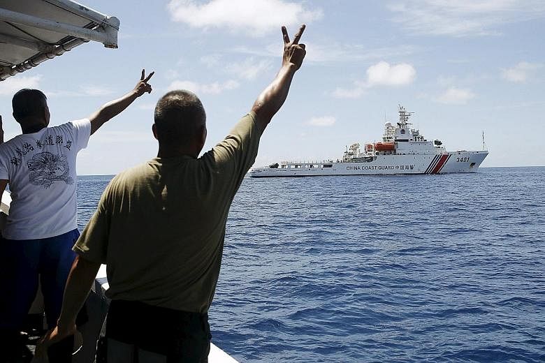 Filipino soldiers gesturing at a Chinese coast guard vessel on the disputed Second Thomas Shoal, part of the Spratly Islands, in 2014. The arbitration case filed by the Philippines on its disputes with China in the South China Sea is drawing a lot of