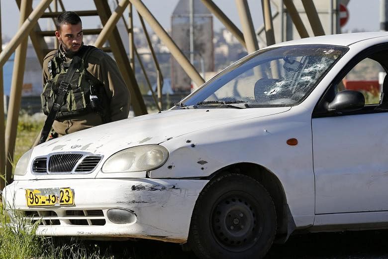 The car driven by the Palestinian woman who rammed it into an Israeli soldier, injuring him, yesterday in the occupied West Bank. She was shot dead by other soldiers.