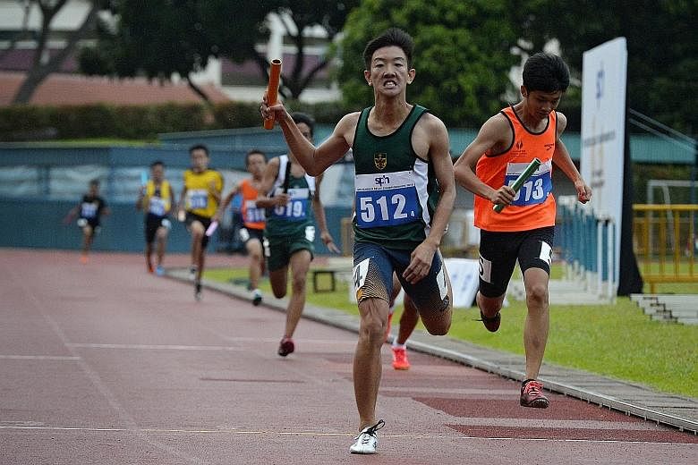 Raffles Institution's Matz Chan, 14, crossing the finish line in the boys' 4x200m C Division race at the SPH Schools Relay Championships at the Bukit Gombak Stadium yesterday. The RI quartet clocked 1min 40.91sec to finish ahead of Singapore Sports S
