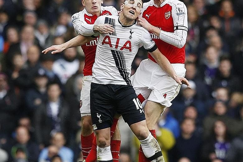 Arsenal's Hector Bellerin (left) and Per Mertesacker trying to beat Tottenham's Harry Kane to the ball. Kane scored Spurs' second goal but Arsenal salvaged a point through Alexis Sanchez.