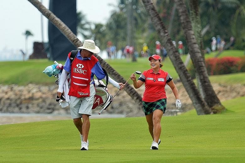 South Korean Jang Ha Na sharing a light-hearted moment with her caddy at the Sentosa Golf Club. After the third round of the HSBC Women's Champions yesterday, the world No. 10 is one stroke ahead of Thailand's Pornanong Phatlum going into today's fin