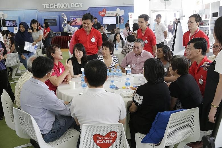 Mr Chan (standing, left) interacting with participants at a People's Association SGfuture session yesterday. It focused on lifelong learning for senior citizens and how the community can support them - which the PA hopes to do by linking them up with