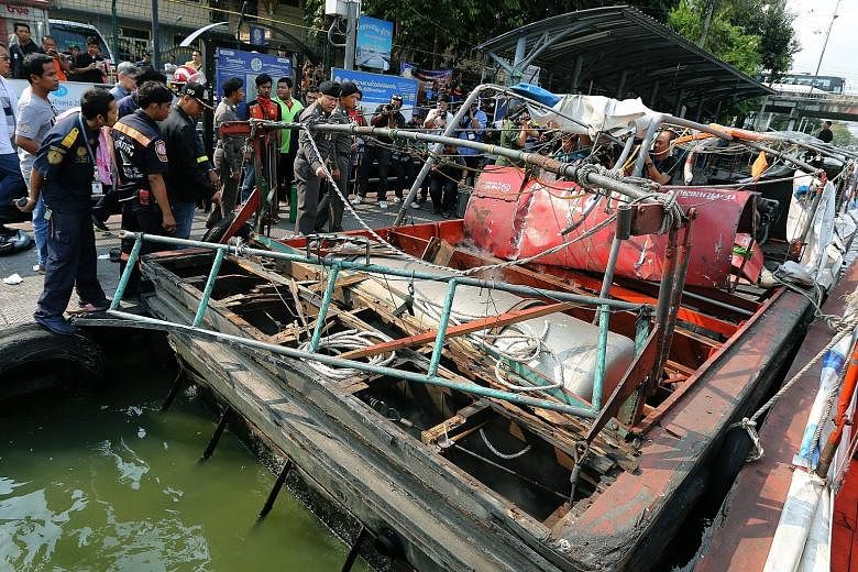 Police officers and officials (left) inspecting what is left of the commuter boat at Wat Thep Leela Pier in Bangkok yesterday. An initial police investigation suggested the explosion (below left) was caused by a fuel leak.