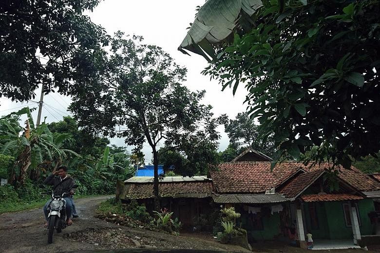 (Above) The dirt trail leading to Pondok Pesantren Ibnu Mas'ud, an Islamic boarding school in Bogor, is barely wide enough for a small car or pick-up truck. (Below) Mr Jumadi, a staff member who claims he handles the school's community relations, say