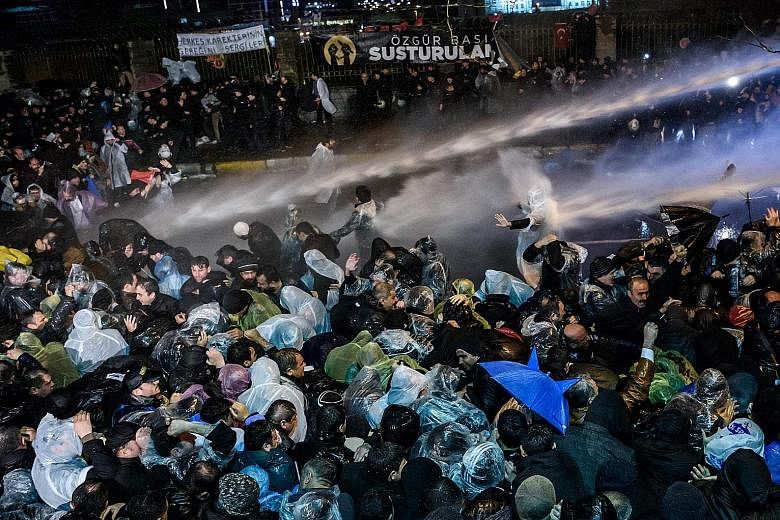 Turkish riot police using water cannons and tear gas to disperse supporters at the Zaman daily's headquarters in Istanbul just before midnight on Friday. "The Constitution is suspended," the newspaper, which managed to print its latest issue after th