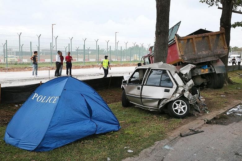 The tipper truck and car in Changi Coast Road after the collision. According to Shin Min Daily News, Mr Zailee's container truck had broken down along the road, and mechanics went down in the car to repair it.