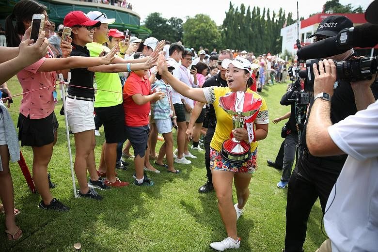 South Korean golfer Jang Ha Na, 23, going on a lap of honour around the 18th green of Sentosa Golf Club's Serapong course with her HSBC Women's Champions trophy in tow. The world No. 10 shot a seven-under 65 yesterday for a 269 winning total at the U