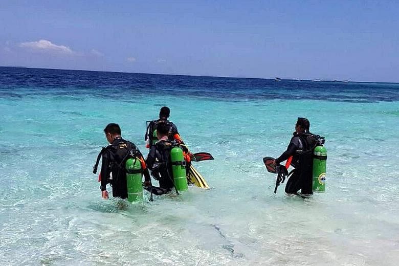 Malaysia has tasked its first four dive marshals (pictured) to act as "undersea policemen" to prevent divers from damaging the coral around Sipadan Island, which is located off Sabah. The waters around Sipadan are popular with divers around the world