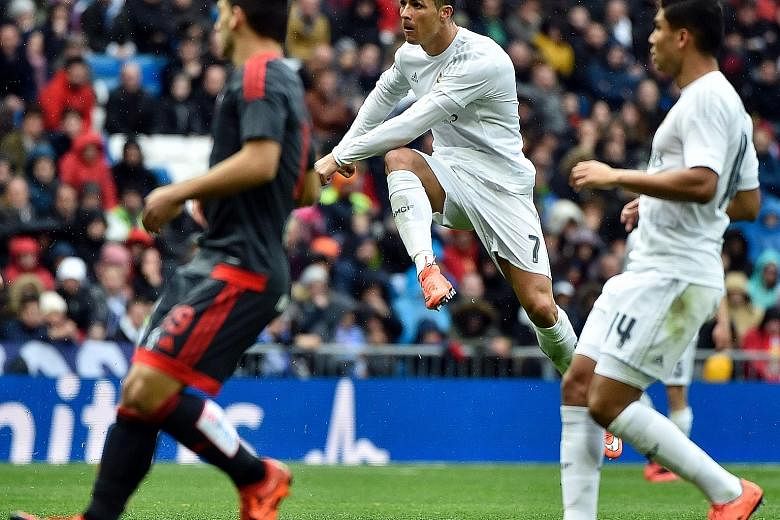 Portuguese forward Cristiano Ronaldo scoring one of his four goals against Celta Vigo in Madrid. He is now the second-highest scorer in Primera Liga history with 252 goals in only 228 games.