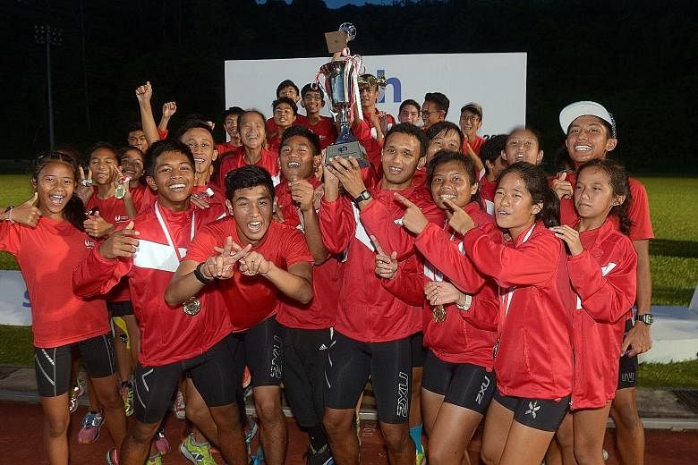 (Above) Athletes from the Singapore Sports School celebrating yesterday after being crowned overall champions of the SPH Schools Relay Championships for the sixth consecutive year. (Right) Prem Sathiamoorthy, from the triumphant Raffles Institution 4