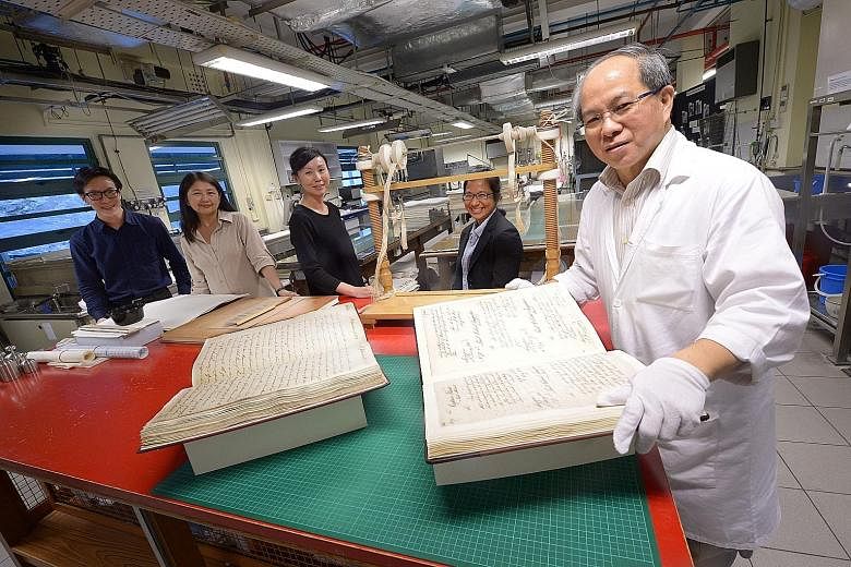 From left: Mr Wong, Dr Phang, Ms Chee at the Archives Conservation Laboratory with assistant archivist Abigail Huang and Mr Chng.