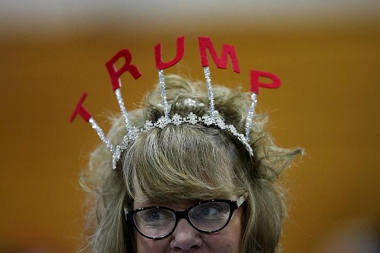 Voters (left, from top) showing their support for US Republican presidential candidate Donald Trump - with headgear and a shoe signed by him - at campaign rallies in the Michigan cities of Cadillac and Warren last Friday. Mr Trump has a polling lead 