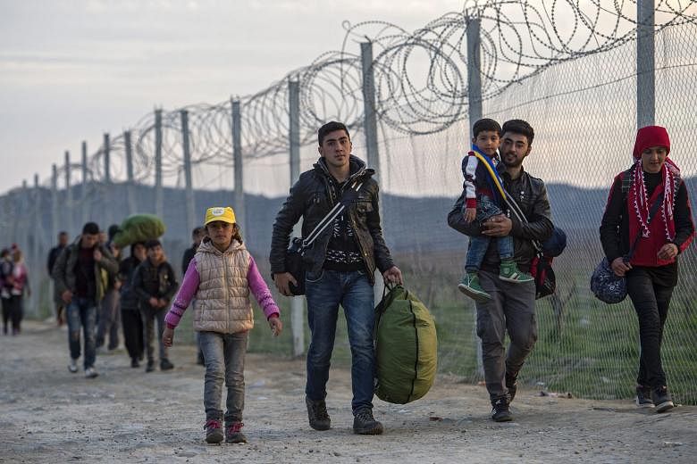 Refugees crossing the border between Greece and Macedonia. The writer says the failure of business to engage on the issue of the recent migrant surges in Europe has greatly aggravated the situation. 