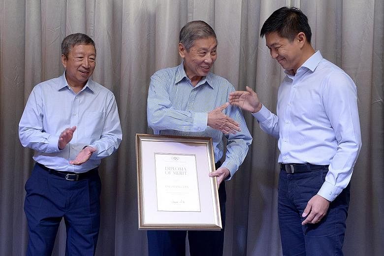 (Left) SNOC secretary- general Chris Chan and Singapore's first Olympic medallist Tan Howe Liang with SNOC president Tan Chuan-Jin after receiving their awards at the ceremony last night. (Top) SNOC vice-president Tan Eng Liang, who also received the