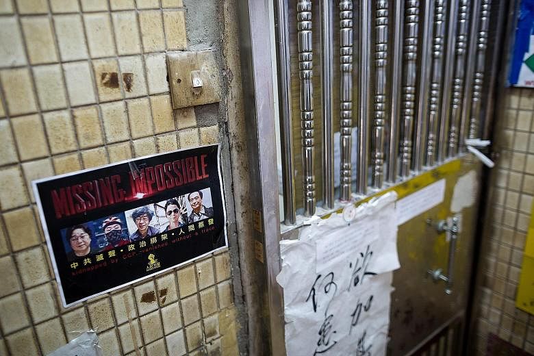 A flier outside a bookstore in Hong Kong with photos of the five booksellers previously thought missing. An e-mail written by one bookseller last November, indicating that he was afraid his associate had been kidnapped by Chinese agents, adds to susp