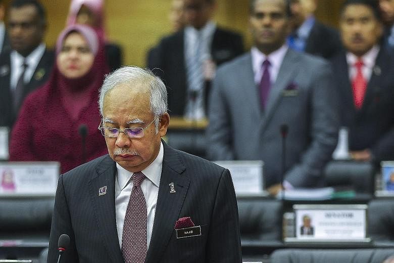 Malaysian PM Najib Razak in Kuala Lumpur yesterday observing a moment of silence to mark the second year since the disappearance of Flight MH370.