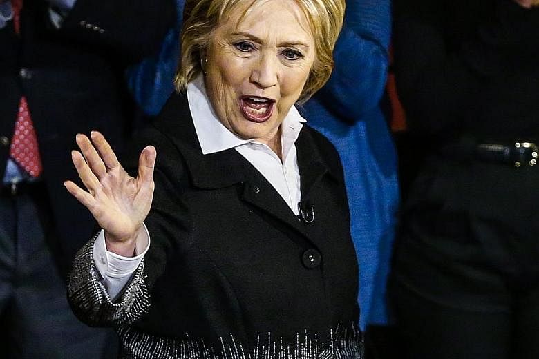 Mrs Hillary Clinton on stage at a town hall meeting in Detroit, Michigan, on Monday. She is leading Mr Sanders by almost 200 pledged delegates won in earlier primaries and caucuses.
