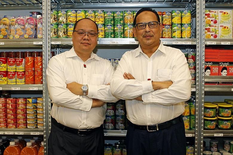 My Outlets president Ronnie Tan (far left) with Mr Malek, the chief executive. The company assists emerging SMEs in the halal food industry to expand and grow.