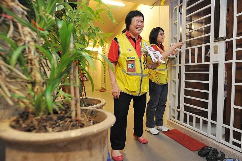 The mother and daughter having a friendly conversation with Mr Mook Woon Kun, 68, a resident of Compassvale Street, while passing him fliers on dengue prevention. The hope is that people will be more receptive to such volunteers, who are neighbourhoo
