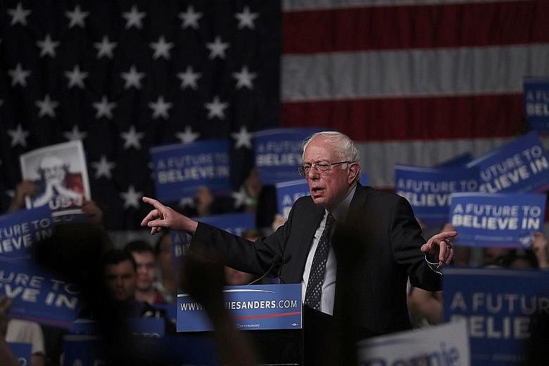 Democratic presidential hopeful Bernie Sanders speaking to his supporters at a campaign rally in Miami, Florida, on Tuesday night. The 74-year-old won 49.9 per cent of the votes in the north-eastern industrial state of Michigan, defying all polls bef