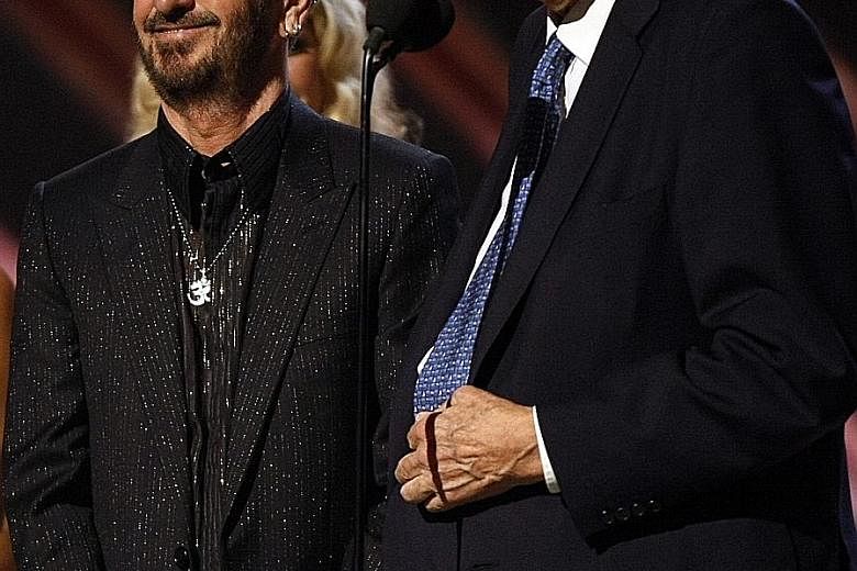 Producer George Martin (left) and former Beatles drummer Ringo Starr receive the trophy for Best Compilation Soundtrack Album at the Grammy Awards in Los Angeles in 2008.