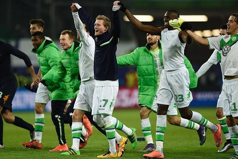 Wolfsburg forward Andre Schuerrle (in black) and his team-mates acknowledge their fans at the Volkswagen Arena after the Bundesliga side's 1-0 victory over Belgian outfit Gent sent them through to the Champions League quarter-finals for the first tim
