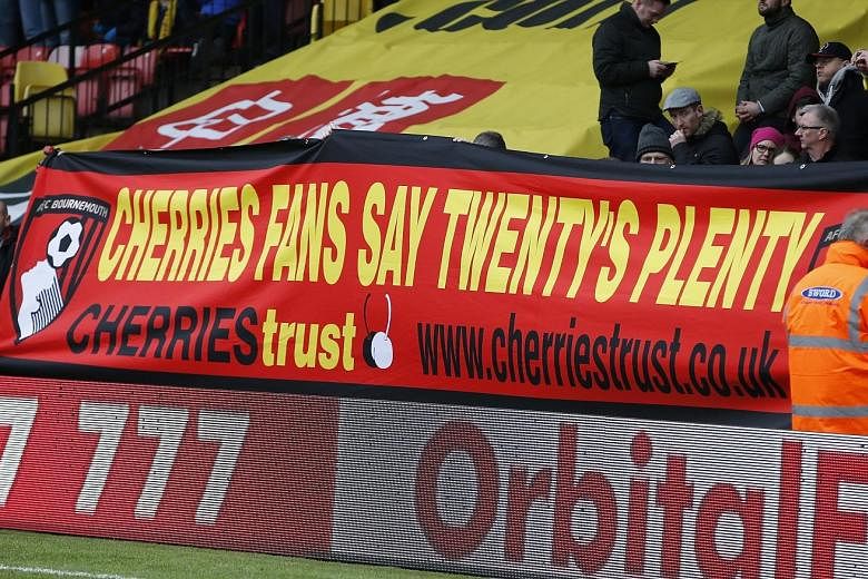 Bournemouth fans displaying a poster at Watford revealing their thoughts about away ticket prices. While they did not get the figure they lobbied for, fan representatives have expressed approval at the £30 price caps.