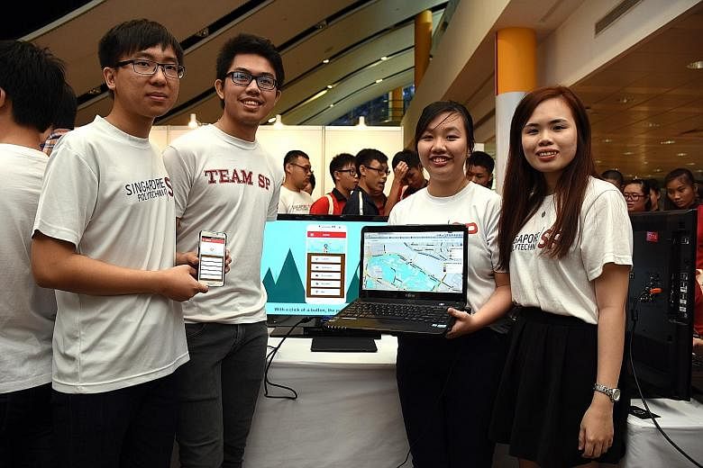 Singapore Poly students (from left) Nicolas Wee, Deswanto, Claris Tham and Lee Wei Yan demonstrating the Call Police app they designed at the school's annual Project Showcase yesterday. Fellow team member Tng Xin Kai was not pictured.