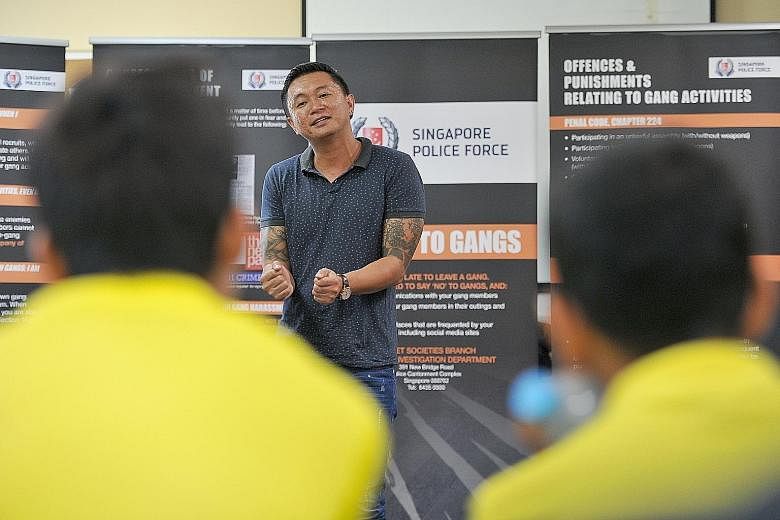Mr Kim (left), who was in a gang for 10 years and is now a pottery artist, sharing his experiences with teens at Camp Ace, aimed at youngsters associated with gangs.