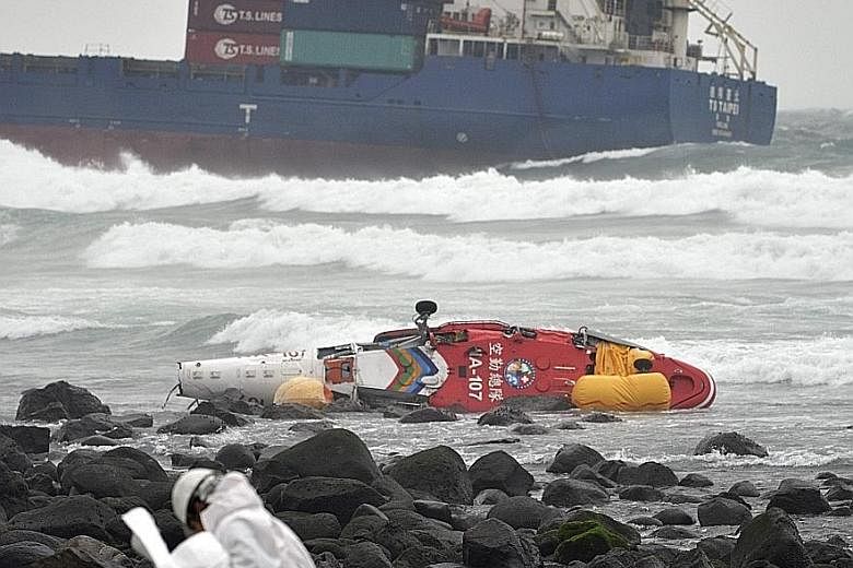 One passenger was killed when a rescue helicopter with five on board lost control and plunged into waters off New Taipei City in northern Taiwan yesterday. The helicopter had been monitoring an oil spill from a cargo vessel (in the background) that b