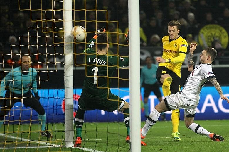 Dortmund striker Marco Reus (centre) scoring against Tottenham's French goalkeeper Hugo Lloris to put his team 2-0 up. While both sides are second in their leagues, the 3-0 result showed the gulf between them and Spurs aim to regain their momentum wh