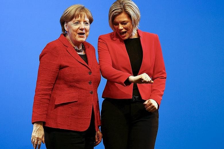 The CDU's candidate in Rhineland- Palatinate Julia Kloeckner (right), and Dr Merkel wearing the same colours during an election rally in Bad Neuenahr- Ahrweiler on Wednesday. Germans go to the polls in three states tomorrow.