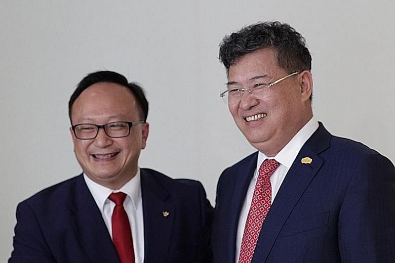 Mr David Su (far left), group chairman of Singapore- based Amare Investment Management Group, with Greenland chairman Zhang Yu Liang. Amare struck a deal yesterday to buy the 19 hotels from Greenland.