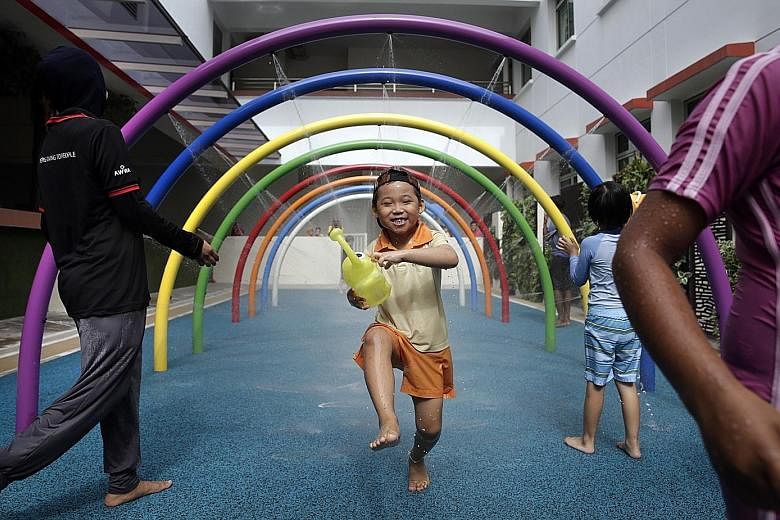 James Lim Yu Hong, a six-year-old pupil attending the AWWA Early Intervention Centre, has a whale of a time playing in the wet area of a new sensory playground installed in AWWA School. The playground, which has wet and dry areas, will help children 