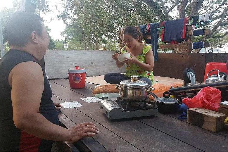 Mr Ong and his wife eat and sleep on the back of his lorry. They cook on a portable stove and sleep on cardboard. The deliveryman, who has been living on his lorry with his pregnant wife, hopes to be able to rent a room by the time their baby is born