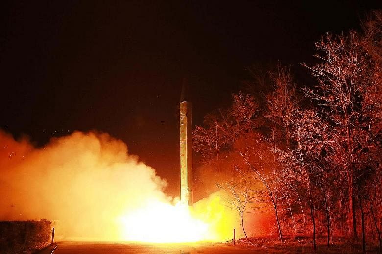 North Korea launching a ballistic rocket during a mobile drill at an undisclosed location. Mr Kim Jong Un was quoted in state media earlier in the week as saying his country had miniaturised nuclear warheads to mount on ballistic missiles.