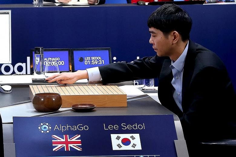 Mr Hassabis (far left), a London- born son of a Chinese- Singaporean mother and a father of Greek-Cypriot descent, is a modern-day polymath. South Korean grandmaster Lee (left) starting Match 3 of the Google DeepMind Challenge Match in Go yesterday i