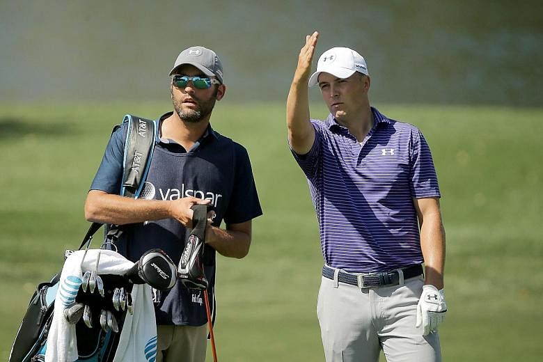World No. 1 Jordan Spieth (right) discussing a hole with his caddie Michael Greller at the Valspar Championship on Friday. The American was relieved to make the cut after a poor start, but remains seven strokes behind the leaders.