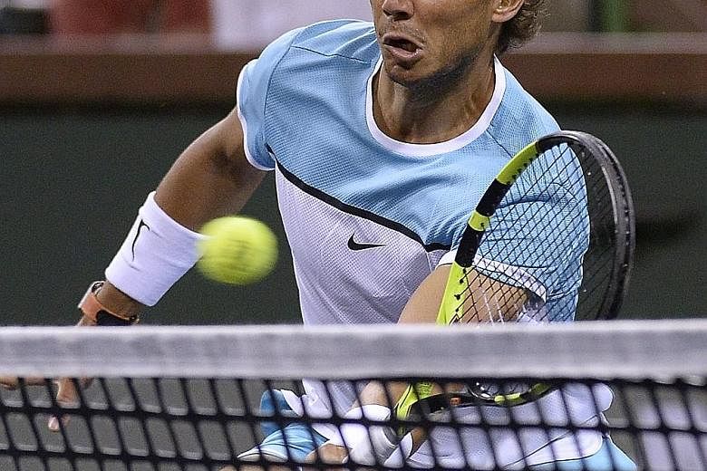 Rafael Nadal in action during the first-round doubles match at the BNP Paribas Open in Indian Wells, which he eventually lost. The Spaniard was riled by former French sports minister Roselyne Bachelot's claim against him and demanded 'justice'.