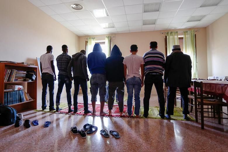 Muslims praying at a hostel for refugees in Satriano, Italy, last month. The possibility of repopulating dying villages in rural parts of the European continent is bringing them a grudging welcome in places like Satriano. As European economies stagnate, a