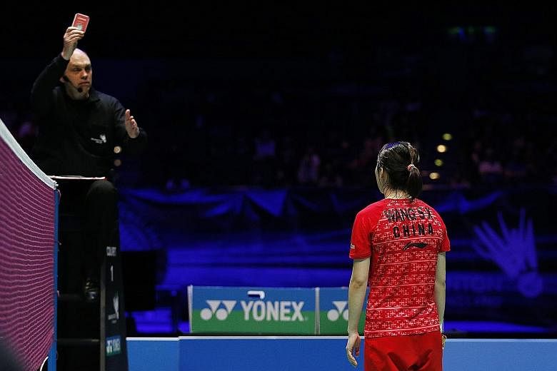 China's Wang Shixian receives a red card during the women's singles final, which she lost to Japan's Nozomi Okuhara 11-21, 21-16, 19-21.