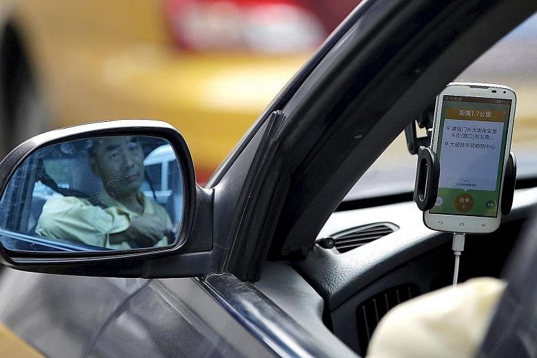 A driver using the Didi Chuxing car-hailing application in Beijing on Sept 22. Industry players are betting that the ride-hailing market in China will become the biggest in the world.