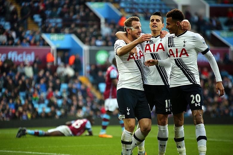 Tottenham's Harry Kane (left) celebrating with team-mates Erik Lamela (centre) and Dele Alli after scoring his second goal in the 2-0 league win over Aston Villa.