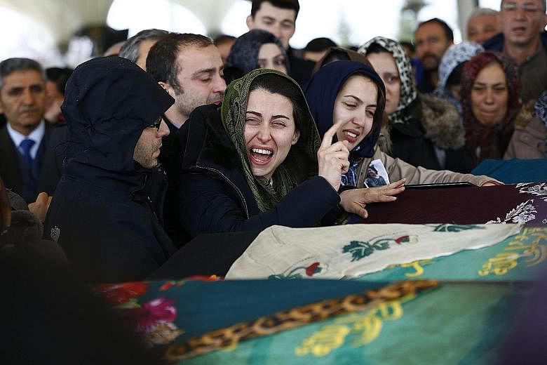 Relatives of a blast victim at his funeral in Ankara yesterday. A car bomb tore through a crowded transport hub in the Turkish capital on Sunday, killing at least 37 people. There was no immediate claim of responsibility, but evidence has been obtain