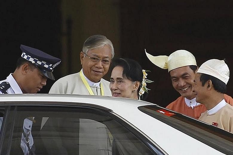 Myanmar's newly elected president Htin Kyaw (second from left) and National League for Democracy leader Aung San Suu Kyi leaving Parliament in the capital Naypyitaw after the election yesterday.