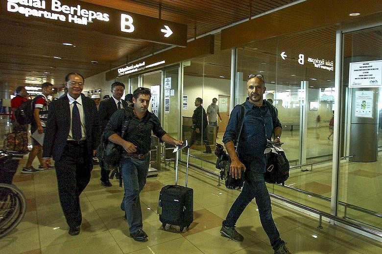 ABC cameraman Eroglu (left) and reporter Besser (with trolley bag) at Kuching International Airport, Sarawak, yesterday. Earlier, they had been told they would face a criminal charge that could land them in jail for two years.