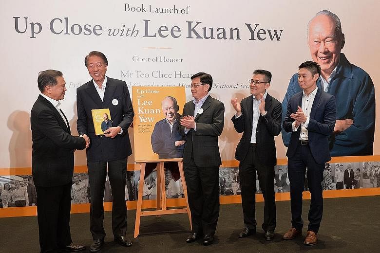 (From far left) Changi Airport Group chairman Liew Mun Leong presenting the book, Up Close With Lee Kuan Yew, to DPM Teo Chee Hean, along with Finance Minister Heng Swee Keat, Maritime and Port Authority chief executive Andrew Tan and Temasek Holding