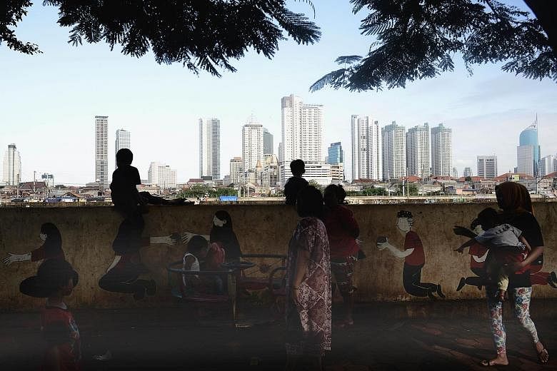 The riverbank opposite the city centre in Jakarta. The World Bank, which revised Indonesia's growth outlook to 5.1 per cent from 5.3 per cent in December, said its revision stemmed from weaker-than-expected global conditions and constraints Jakarta f
