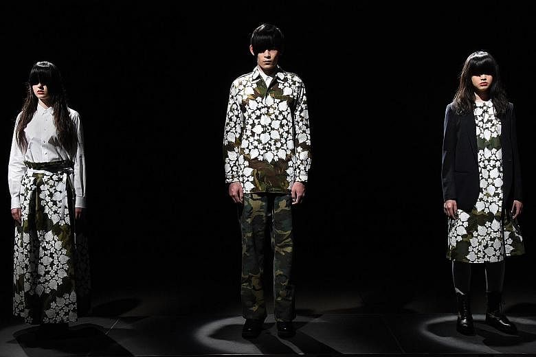 Models in floral silkscreen-printed garments and combat boots by Japanese designer Tsukasa Mikami at Tokyo Fashion Week.